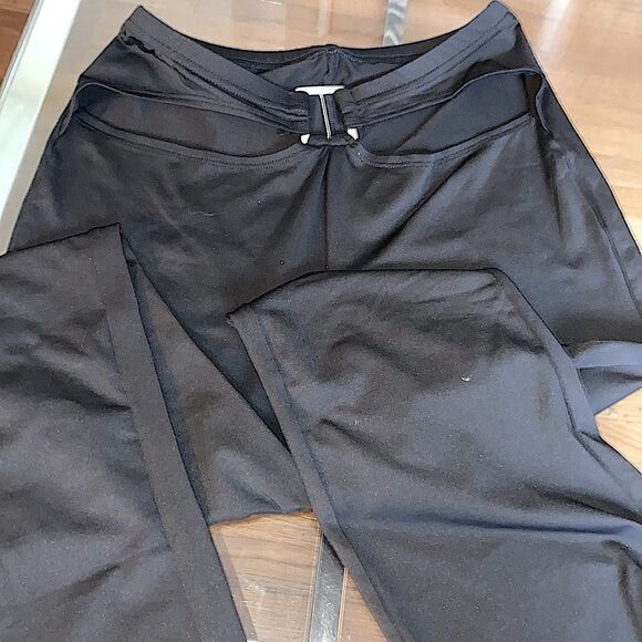 Put on black flare pants with cut out waste accent and silver accessory. Stretch - Picture 11 of 11